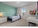 Bright bedroom featuring a large window and a cozy setup at 432 N Patsburg St, Aurora, CO 80018