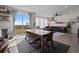 Dining area featuring a table with benches, large windows, and seamless indoor-outdoor living at 432 N Patsburg St, Aurora, CO 80018