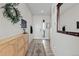 Inviting entryway with a stylish wooden console, decorative mirror, and neutral decor at 432 N Patsburg St, Aurora, CO 80018