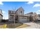 Charming two-story home with a well-manicured lawn, gray siding and a two-car garage at 432 N Patsburg St, Aurora, CO 80018