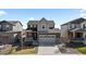 Charming two-story home with a well-manicured lawn, gray siding and a two-car garage at 432 N Patsburg St, Aurora, CO 80018