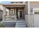 A cozy front porch with stone accents leads to the front door, creating a welcoming entrance at 432 N Patsburg St, Aurora, CO 80018