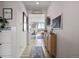 Bright hallway with wood-look flooring leads to an open kitchen and dining area at 432 N Patsburg St, Aurora, CO 80018