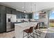 Bright, open kitchen with an island, dark green cabinets, stainless appliances and outdoor views at 432 N Patsburg St, Aurora, CO 80018