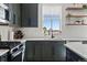 Lovely kitchen with green cabinets, white countertops, modern appliances and natural light at 432 N Patsburg St, Aurora, CO 80018