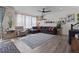Living room features a sectional sofa, patterned rug, and bright natural light at 432 N Patsburg St, Aurora, CO 80018