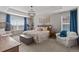 Bright main bedroom featuring a large window, tray ceiling, modern light fixture, and decorative touches at 432 N Patsburg St, Aurora, CO 80018