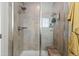 Modern shower with glass doors, gray tile, and a built-in shower bench at 432 N Patsburg St, Aurora, CO 80018