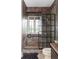 Unique bathroom with stone pebble shower flooring, a window, and a modern glass door at 185 Players Club Dr, Castle Rock, CO 80104
