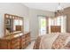 Bright bedroom featuring a dresser and a balcony, with natural light and neutral tones at 185 Players Club Dr, Castle Rock, CO 80104