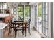 Cozy dining area with natural light, fireplace, and access to outdoor patio at 185 Players Club Dr, Castle Rock, CO 80104