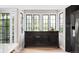 Dining room with windows to exterior, built-in sideboard, and wood floor at 185 Players Club Dr, Castle Rock, CO 80104