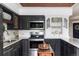 Nicely decorated and remodeled kitchen with granite counters and backsplash at 185 Players Club Dr, Castle Rock, CO 80104