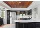 Modern kitchen with black cabinets, stainless steel appliances, and butcher block countertops at 185 Players Club Dr, Castle Rock, CO 80104