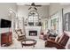 Bright living room with fireplace, large windows, and hardwood floors at 185 Players Club Dr, Castle Rock, CO 80104