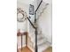 Elegant staircase with carpeted steps, black banister, and decorative wreath at 185 Players Club Dr, Castle Rock, CO 80104