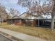 Brick home with carport and landscaping at 502 S Carr St, Lakewood, CO 80226