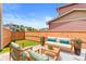 Relaxing backyard featuring outdoor seating with artificial turf, ideal for entertaining and leisure at 11684 Park South Loop, Parker, CO 80138
