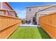 Spacious backyard with artificial turf, patio and fenced perimeter, perfect for privacy and outdoor enjoyment at 11684 Park South Loop, Parker, CO 80138