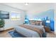 Comfortable bedroom features stylish mountain mural, natural light, and warm, inviting tones at 11684 Park South Loop, Parker, CO 80138
