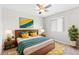 Bedroom featuring a queen-sized bed, large painting, ceiling fan and stylish decor at 11684 Park South Loop, Parker, CO 80138