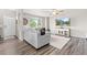 Cozy living room featuring a gray sectional sofa, large window, and entertainment center at 11684 Park South Loop, Parker, CO 80138