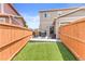 Charming backyard featuring synthetic grass and patio seating with a full-length fence at 11684 Park South Loop, Parker, CO 80138