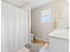 Clean bathroom showcasing a shower with a white curtain, window, and tile floors at 11684 Park South Loop, Parker, CO 80138