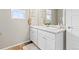 Well-lit bathroom featuring double sinks, white cabinets, and stylish decor at 11684 Park South Loop, Parker, CO 80138