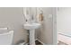 Cozy half-bathroom featuring a pedestal sink, modern faucet, and tile flooring at 11684 Park South Loop, Parker, CO 80138