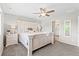Spacious bedroom featuring a ceiling fan, plush carpeting, and a stylish ensuite bathroom at 11684 Park South Loop, Parker, CO 80138