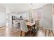 Bright dining area featuring a rustic wooden table, stylish chairs, and modern lighting fixture at 11684 Park South Loop, Parker, CO 80138