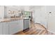 Open concept kitchen with stainless steel dishwasher, granite countertops, and wood flooring at 11684 Park South Loop, Parker, CO 80138
