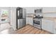 Well-equipped kitchen with stainless steel appliances, white cabinetry, and plenty of counter space at 11684 Park South Loop, Parker, CO 80138