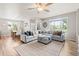 Spacious living room with a comfortable sectional sofa, large windows, and stylish ceiling fan at 11684 Park South Loop, Parker, CO 80138