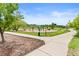 Community playground with various play structures, landscaping, and a winding pathway at 11684 Park South Loop, Parker, CO 80138