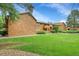Multi-Gathering dwelling exterior with green lawn and mature trees at 3335 S Ammons St # 6-105, Lakewood, CO 80227