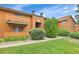 Well-maintained condo exterior with vibrant landscaping and manicured lawn at 3335 S Ammons St # 6-105, Lakewood, CO 80227
