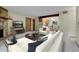 Spacious open-concept living and kitchen area with stone fireplace feature at 3335 S Ammons St # 6-105, Lakewood, CO 80227
