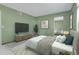Comfortable bedroom with a large mirror and soothing green walls at 3335 S Ammons St # 6-105, Lakewood, CO 80227