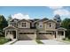Charming townhome with a two-car garage, covered front porch and attractive architectural details at 6759 Juniper Dr, Thornton, CO 80602