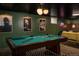 A basement rec room includes a pool table, lounge area, and eclectic decor at 7039 Otis Ct, Arvada, CO 80003