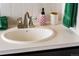 Bathroom sink and vanity with brushed nickel faucet and green towels at 7039 Otis Ct, Arvada, CO 80003