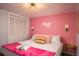 Bedroom with pink lip wallpaper and Hollywood neon sign at 7039 Otis Ct, Arvada, CO 80003