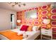 Bright bedroom featuring retro wall covering, modern lamp, and natural light at 7039 Otis Ct, Arvada, CO 80003