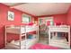 A bedroom with bunk beds and a mirrored closet door reflects the space at 7039 Otis Ct, Arvada, CO 80003