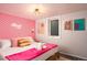 Bedroom with pink lip wallpaper and Hollywood neon sign at 7039 Otis Ct, Arvada, CO 80003