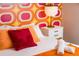 Cozy bedroom with retro wall covering, modern lamp, and comfortable bedding at 7039 Otis Ct, Arvada, CO 80003