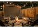 Backyard fire pit area with chairs, string lights, and comfortable seating, perfect for entertaining at 7039 Otis Ct, Arvada, CO 80003