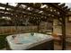 Hot tub with pergola, string lights, and picnic table at 7039 Otis Ct, Arvada, CO 80003
